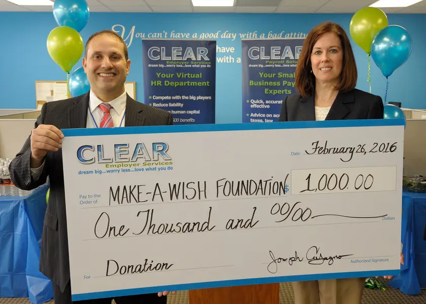 CLEAR Employer Services presenting a donation check to the Make-A-Wish Foundation